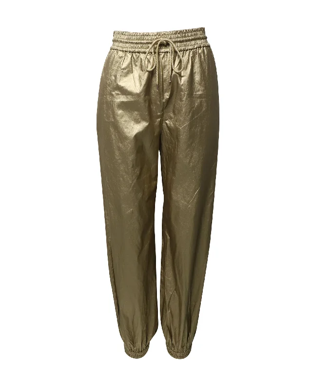 Pleated women trousers for a sophisticated and formal lookZimmermann Rhythmic Drawstring Pants in Gold Viscose